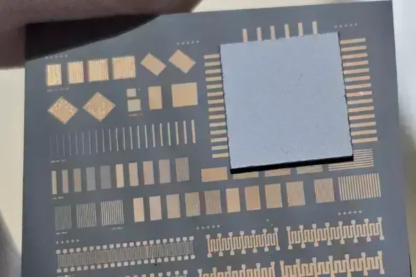 A bonded wafer showing a test pattern on a dark surface with a gray square overlay.