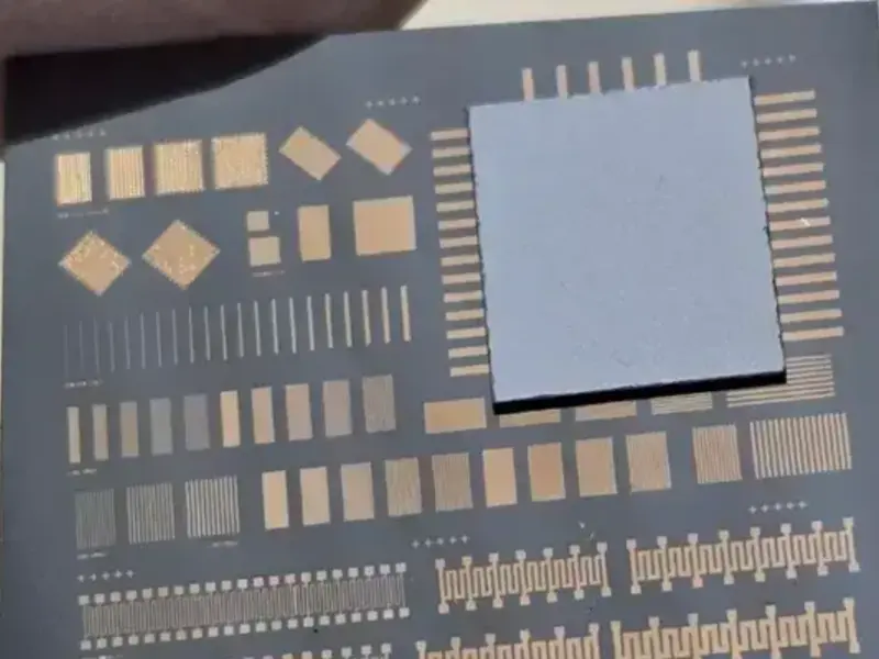 A bonded wafer showing a test pattern on a dark surface with a gray square overlay.